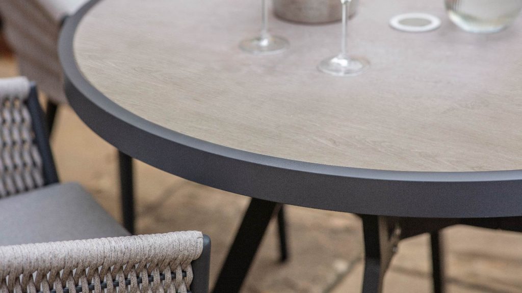 bramblecrest mauritius 110cm round dining table with 4 chairs parasol & base X23AMA110RT lifestyle 4