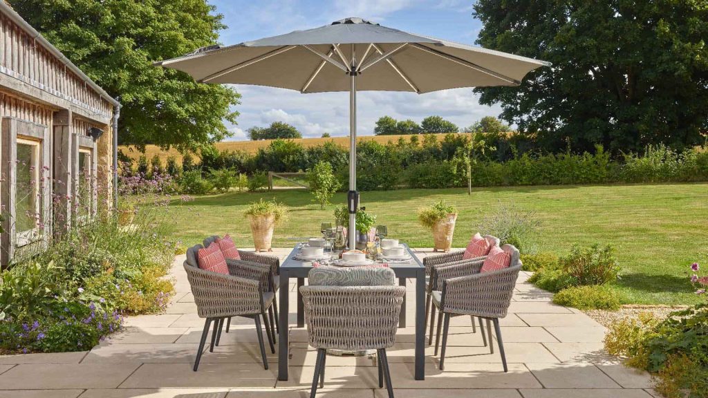 bramblecrest mauritius 164 x 95cm rectangle dining table with 6 chairs & parasol X23AMA164RT1 lifestyle 2