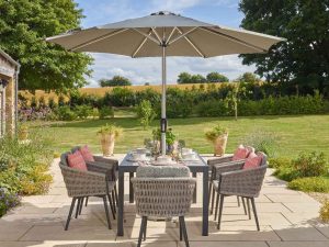 bramblecrest mauritius 164 x 95cm rectangle dining table with 6 chairs & parasol X23AMA164RT1 lifestyle 2