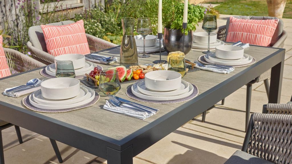 bramblecrest mauritius 164 x 95cm rectangle dining table with 6 chairs & parasol X23AMA164RT1 lifestyle 4