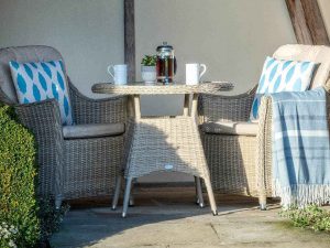 bramblecrest monterey 80cm bistro table with 2 armchairs sandstone X21WSMO80RD1 lifestyle 3